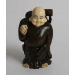 Boxwood and Ivory netsuke of a Motei carrying a large knapsack and gourd Japan, early 20th century