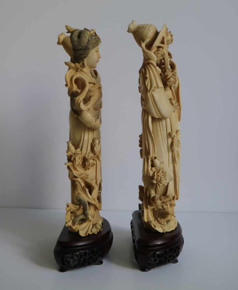 Ivory figures by He Xiangu with flowers symmetrically carved, China Republic period H 28,5 cm + 4,5 - Image 2 of 4