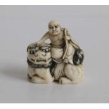 Carved figure of Hotei sitting on a shishi holding Aruyi scepter Japan MEIJI period H 4 cm signed