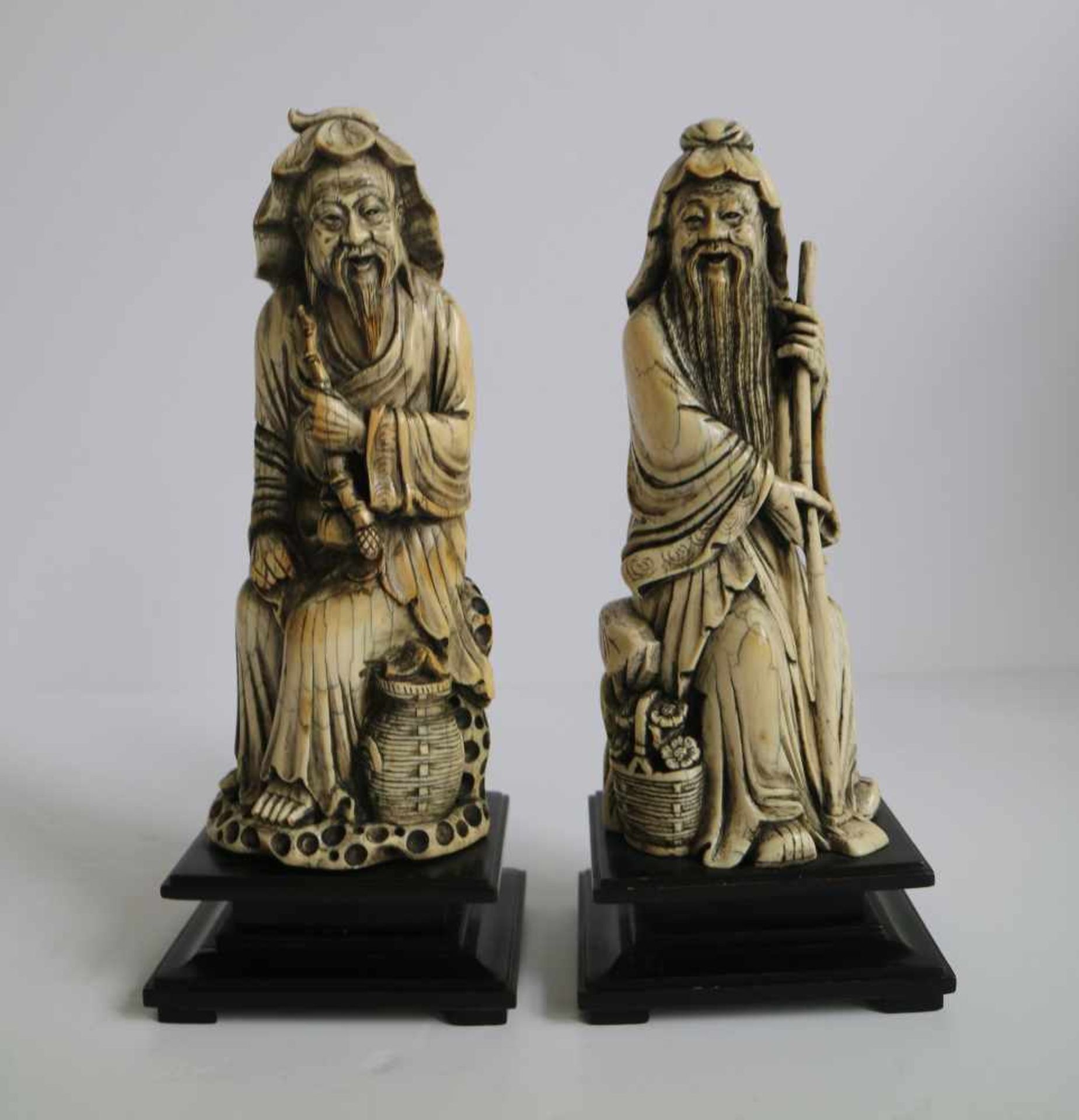 A pair of mammoth ivory arhats China 1970's H 24 cm (with base)