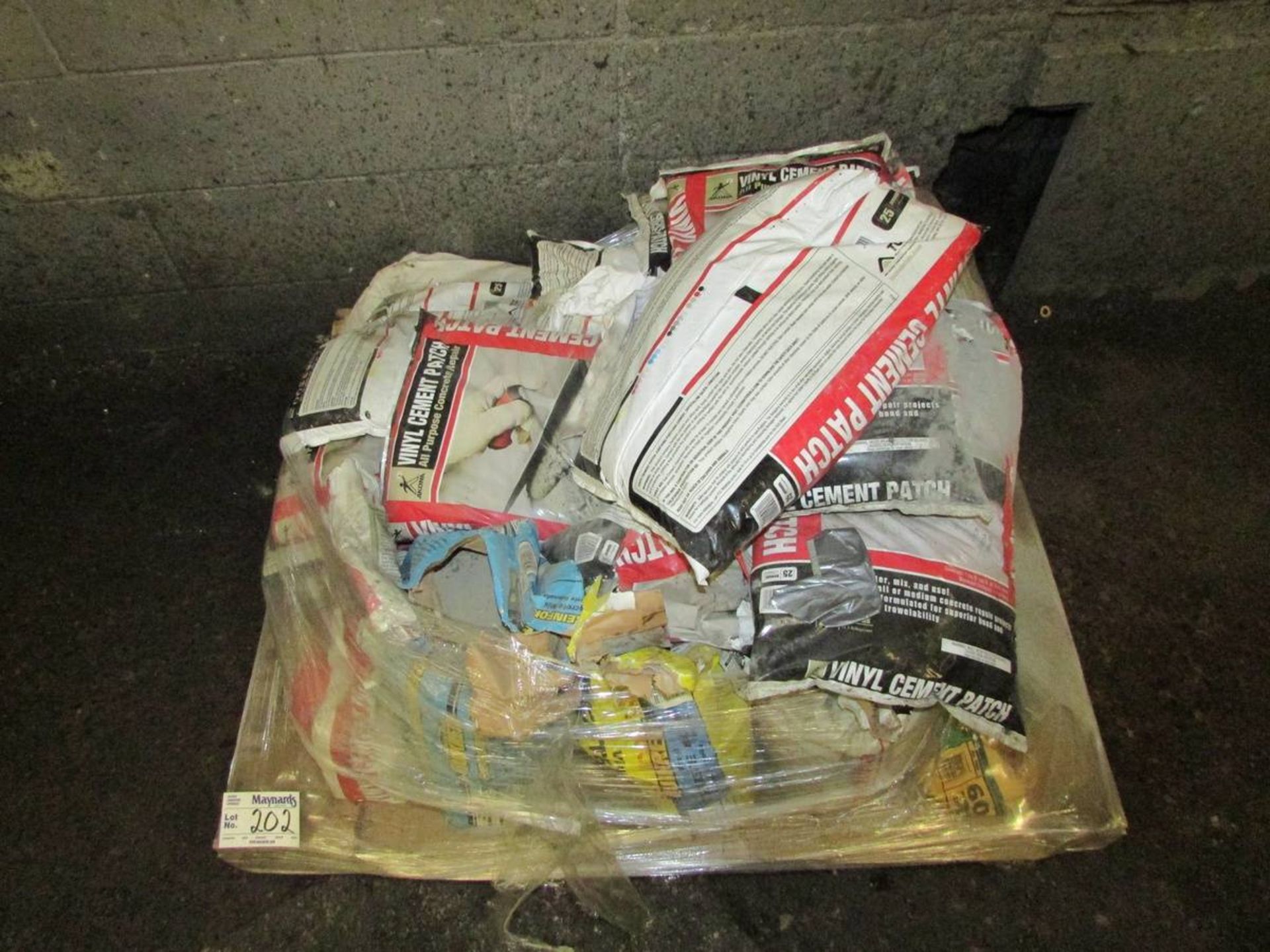 Pallet of Vinyl Cement Patches and Quikrete Bags