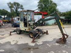 SMC 2.5 WHEELED MINI DIGGER, PIPED FOR BREAKER, FULL HEATER CAB, DOOR HINGE BROKEN BUT IS PRESENT