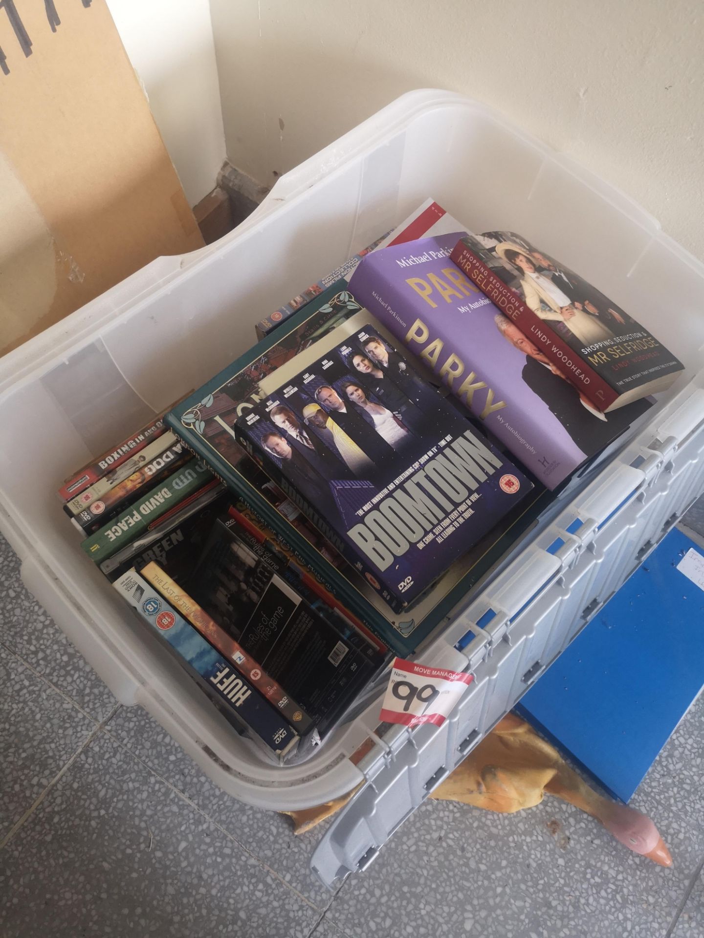 box of assorted books and DVDS