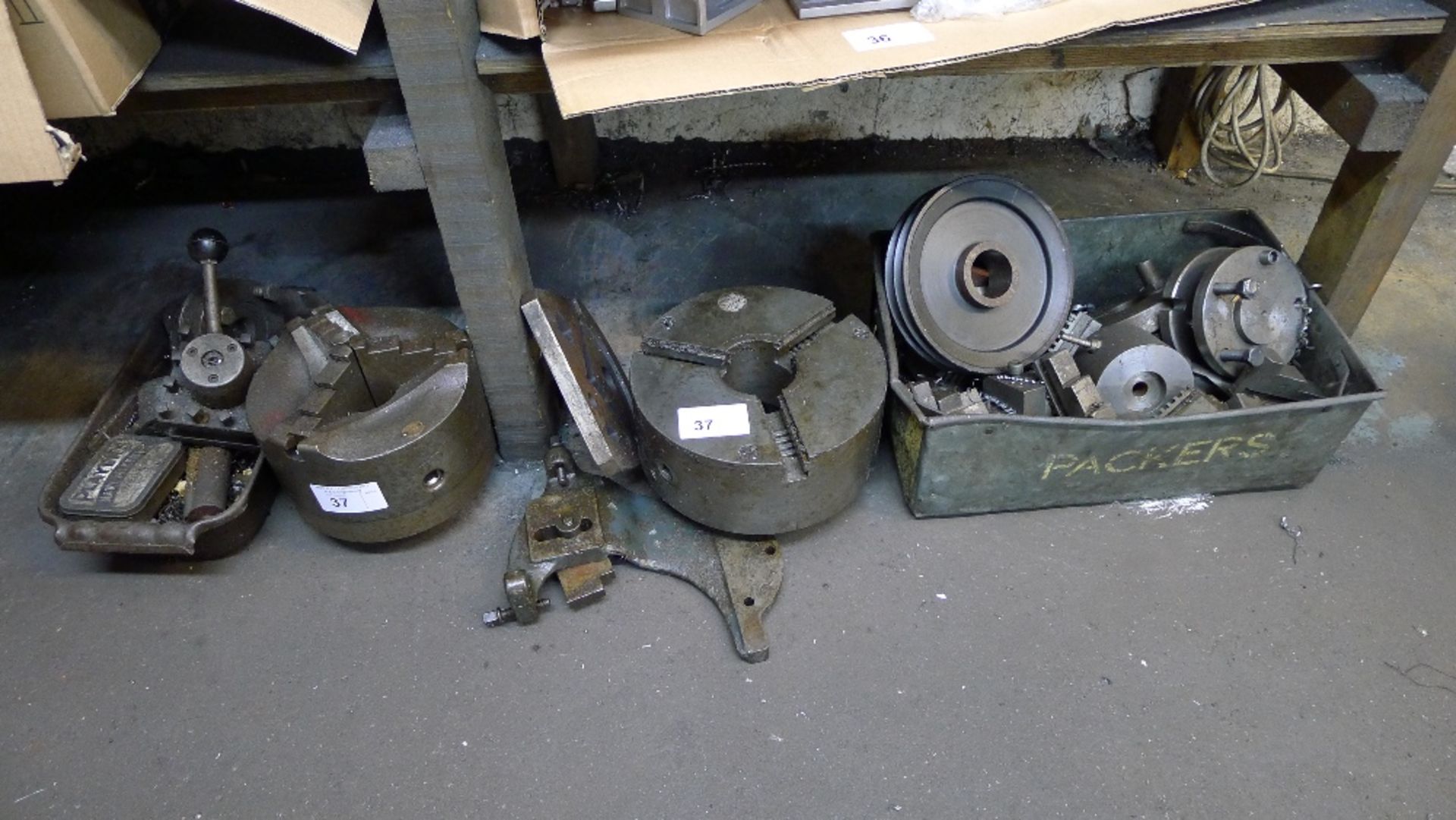 A quantity of various tooling including 2 x 3 jaw chucks, spare jaws, a tool holder etc