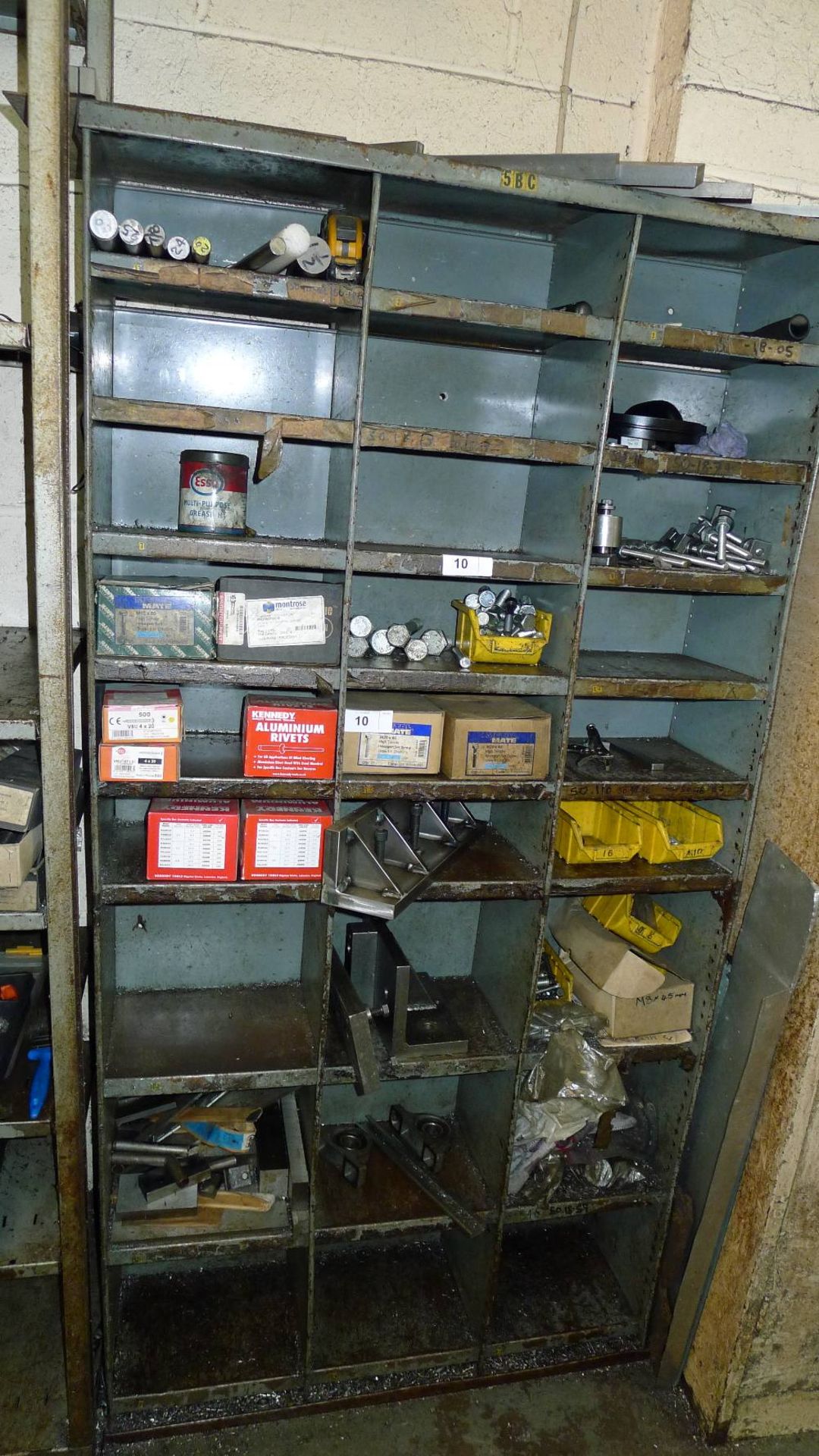 1 storage rack containing a quantity of various items including machine bolts, screws, rivets, angle
