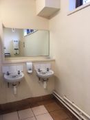 Contents of ladies toilet, 2 x cubicles, 2 x sinks, hand drier, mirror, as lotted.