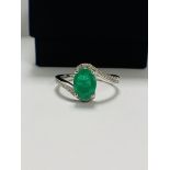 14ct White Gold Emerald and Diamond ring featuring centre, oval cut, medium green Emerald (1.18ct),