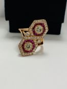 14ct Rose Gold Ruby and Diamond ring featuring centre, 2 round brilliant cut Diamonds (0.67ct), beze