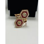 14ct Rose Gold Ruby and Diamond ring featuring centre, 2 round brilliant cut Diamonds (0.67ct), beze