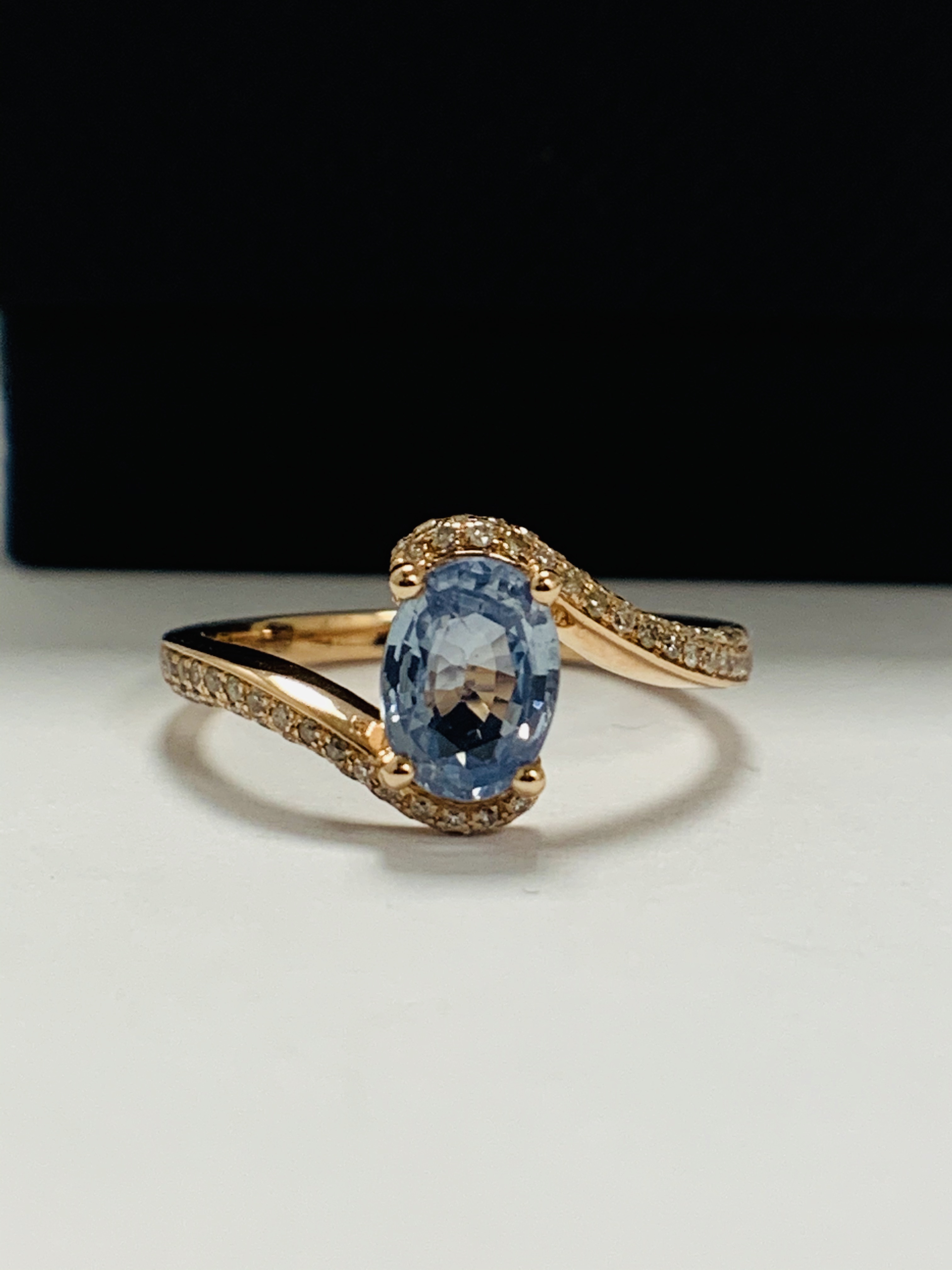 14ct Rose Gold Sapphire and Diamond ring featuring centre, oval cut, blue Sapphire (1.10ct), claw se - Image 2 of 13