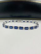14ct Sapphire and Diamond tennis bracelet featuring, 20 oval cut, blue Sapphires (12.72ct TSW), claw