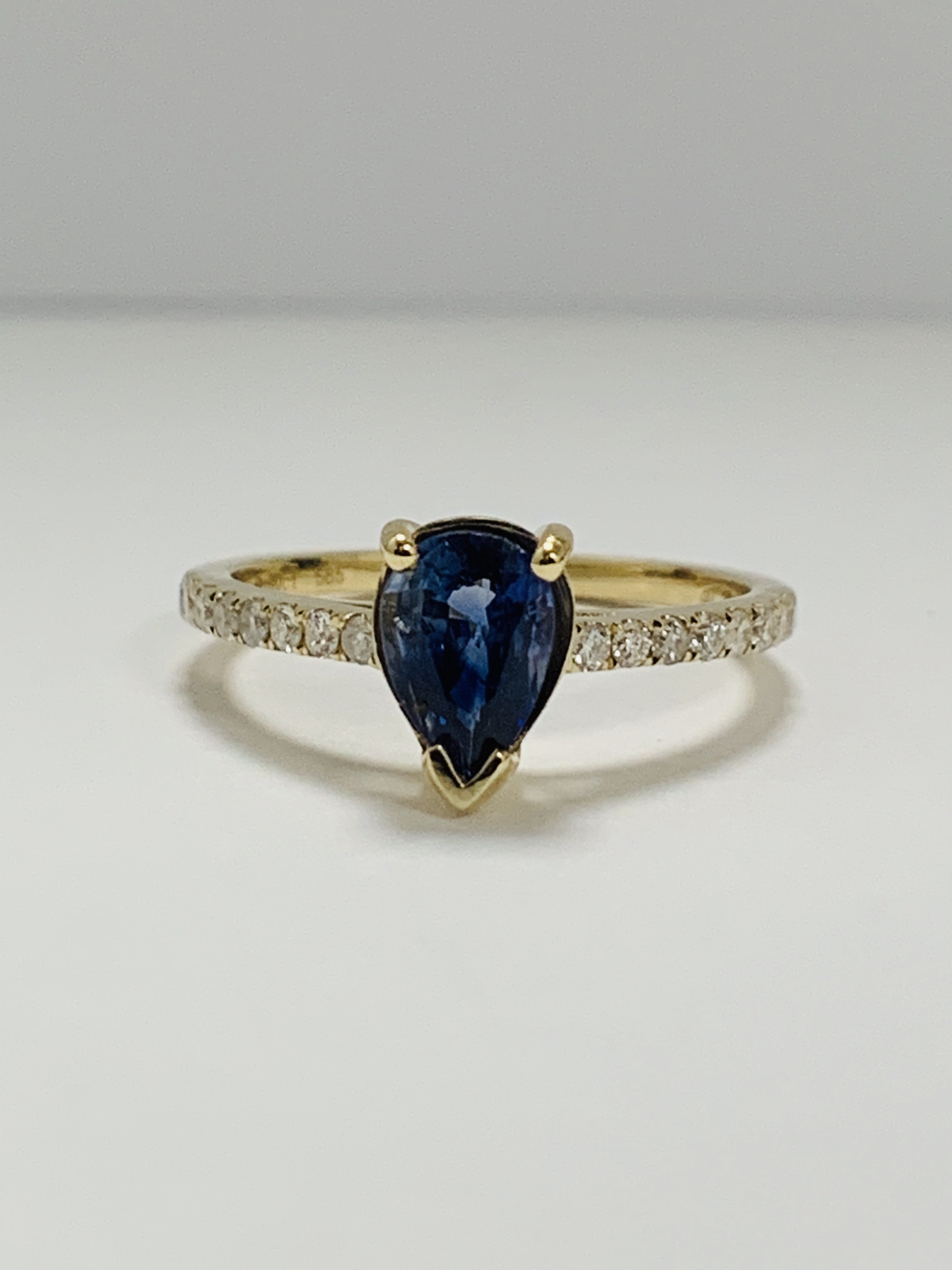 14ct Yellow Gold Sapphire and Diamond ring featuring centre, pear cut, medium blue Sapphire (0.90ct)