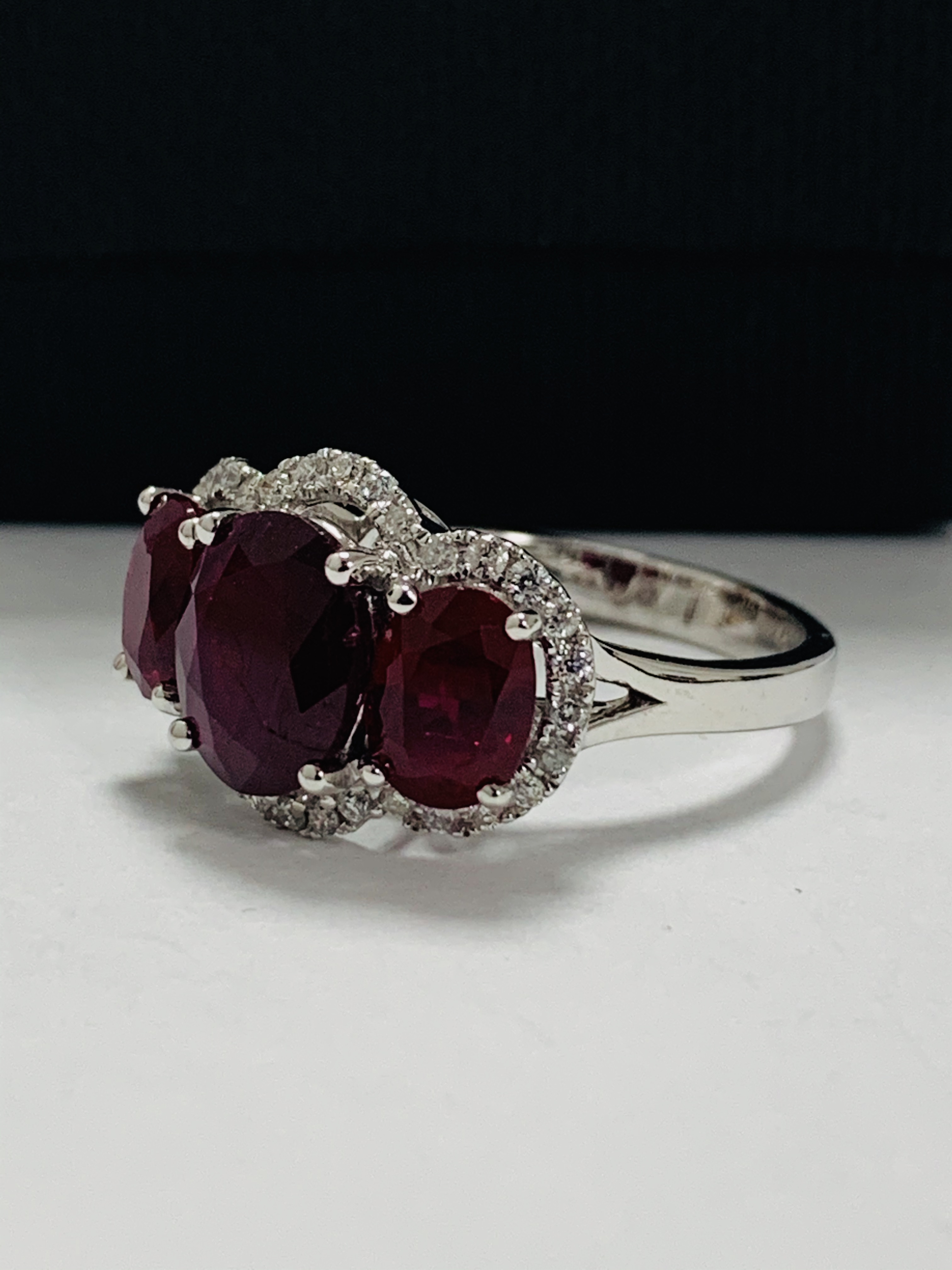 14ct White Gold Ruby and Diamond ring featuring centre, oval cut Ruby (1.67ct), claw set, with 2 ova - Image 2 of 12