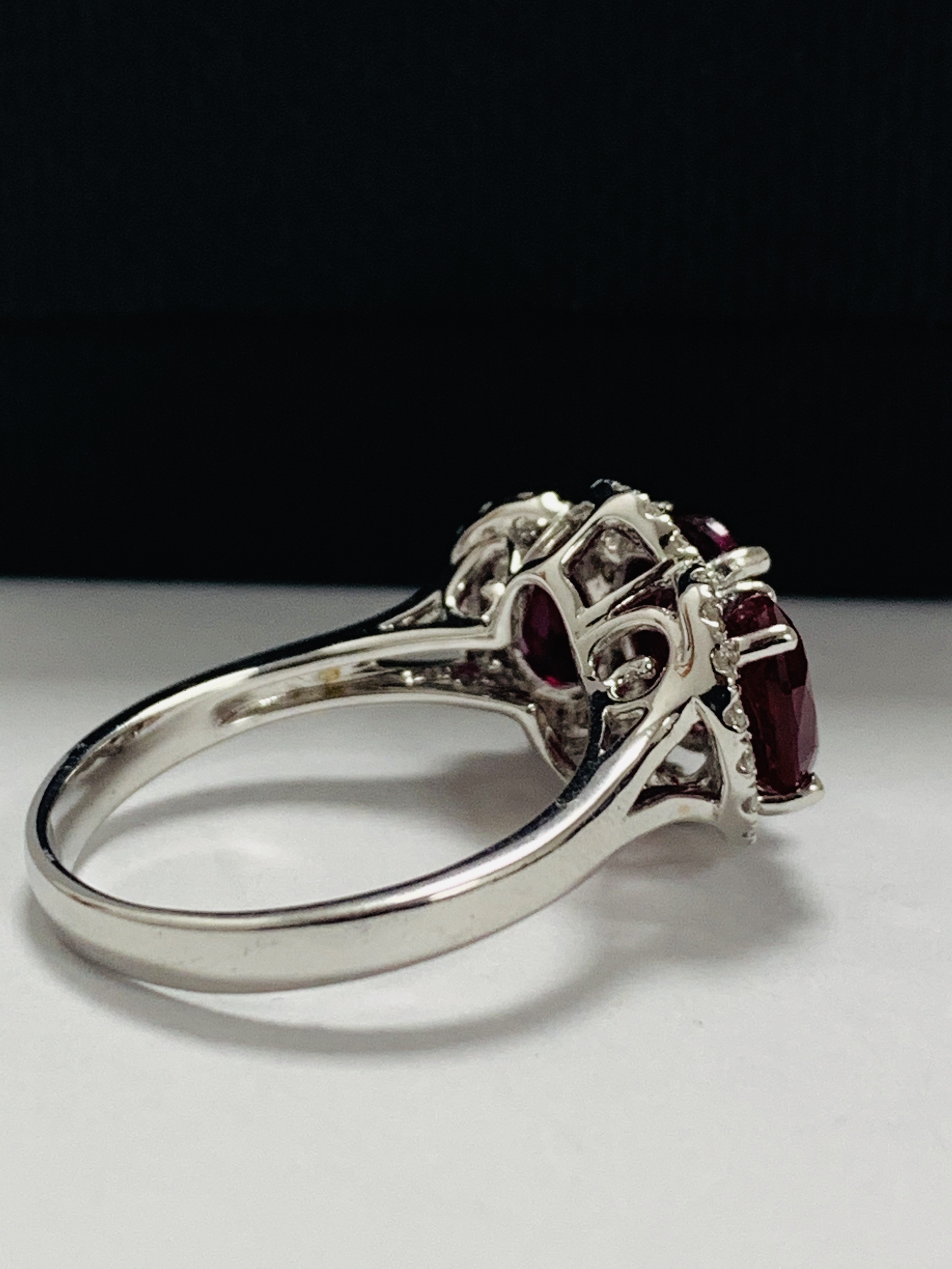 14ct White Gold Ruby and Diamond ring featuring centre, oval cut Ruby (1.67ct), claw set, with 2 ova - Image 6 of 12