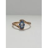 14ct Rose Gold Sapphire and Diamond ring featuring centre, oval cut, blue Sapphire (1.10ct), claw se