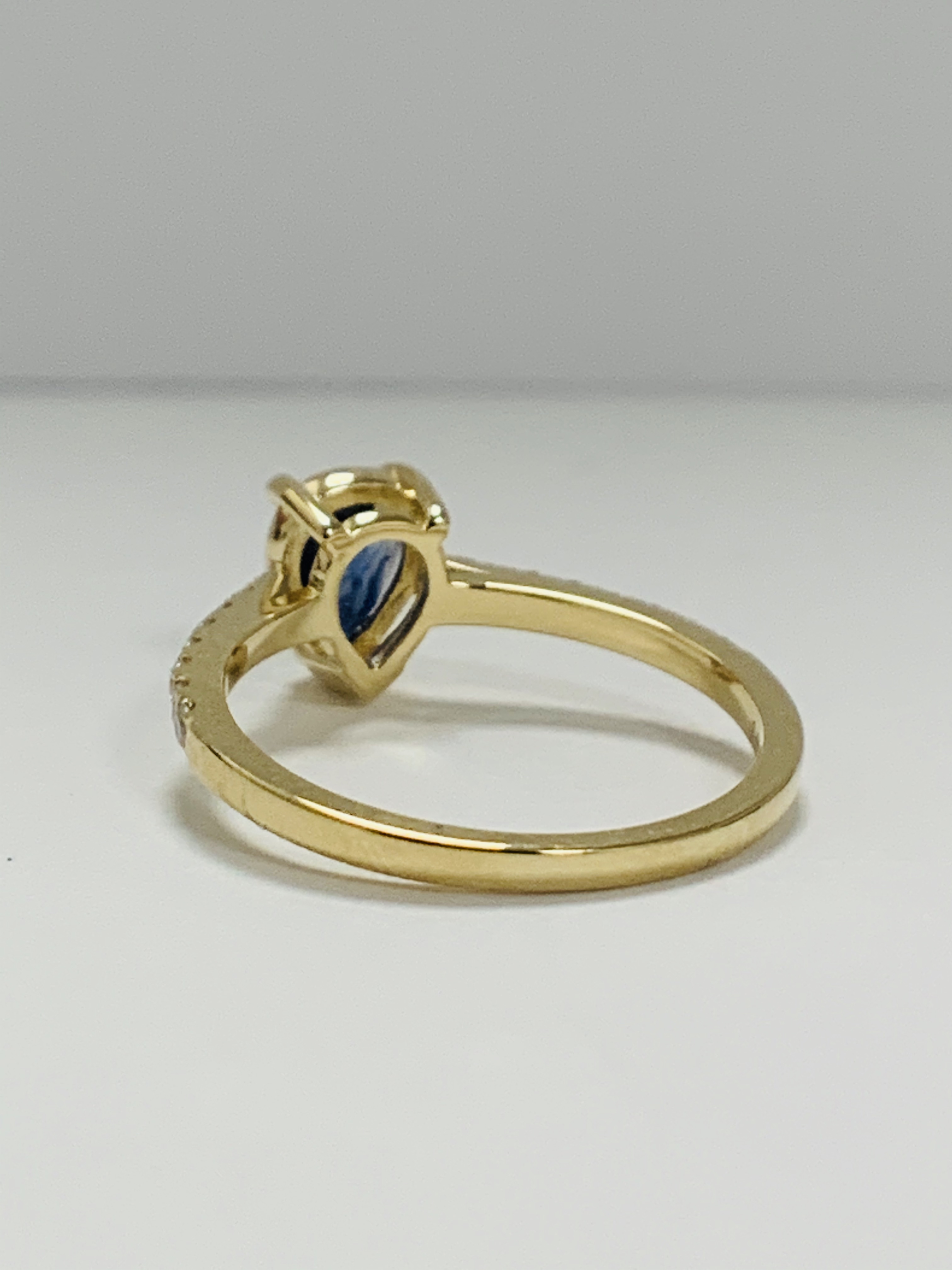 14ct Yellow Gold Sapphire and Diamond ring featuring centre, pear cut, medium blue Sapphire (0.90ct) - Image 4 of 13