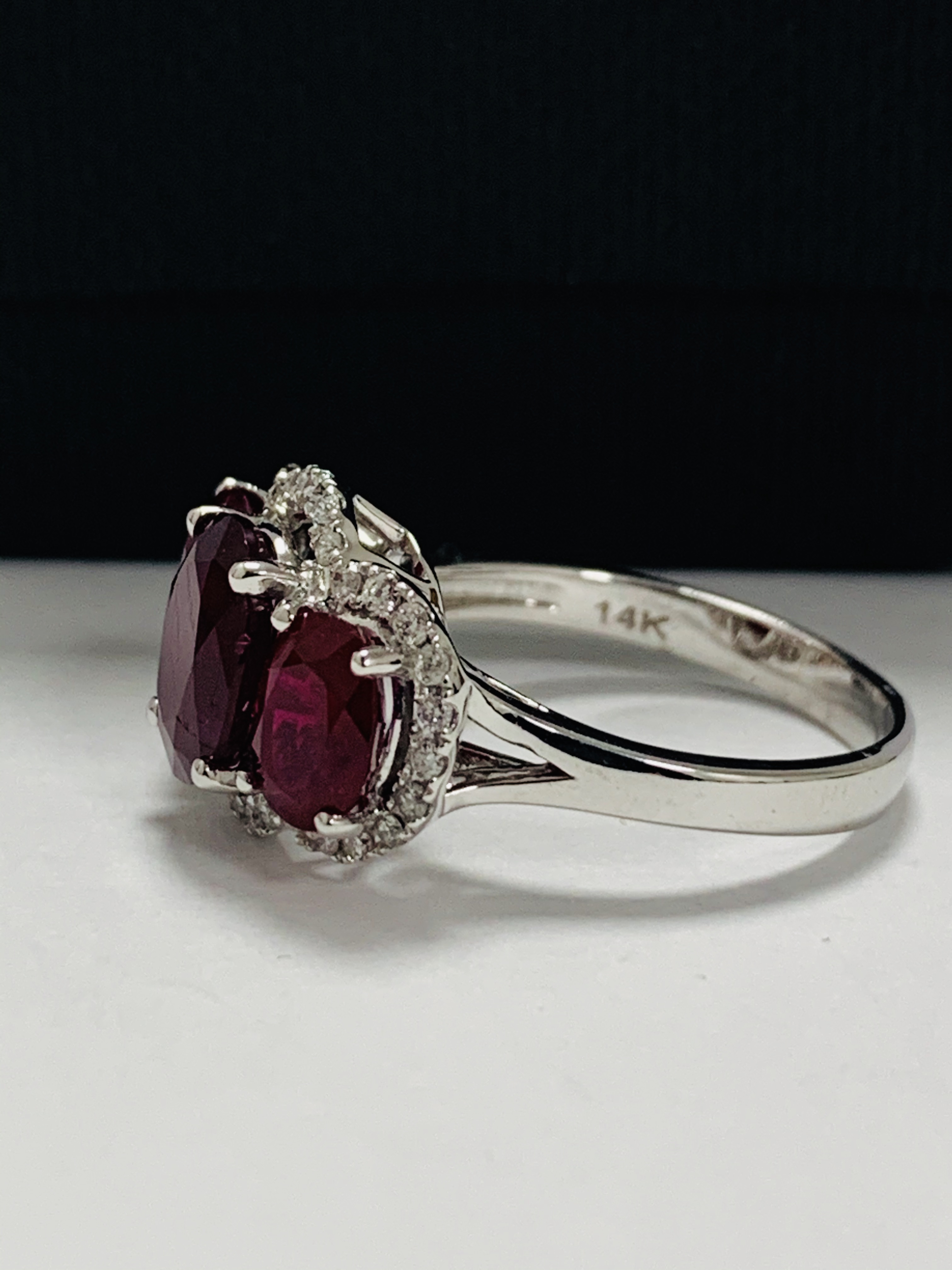 14ct White Gold Ruby and Diamond ring featuring centre, oval cut Ruby (1.67ct), claw set, with 2 ova - Image 3 of 12