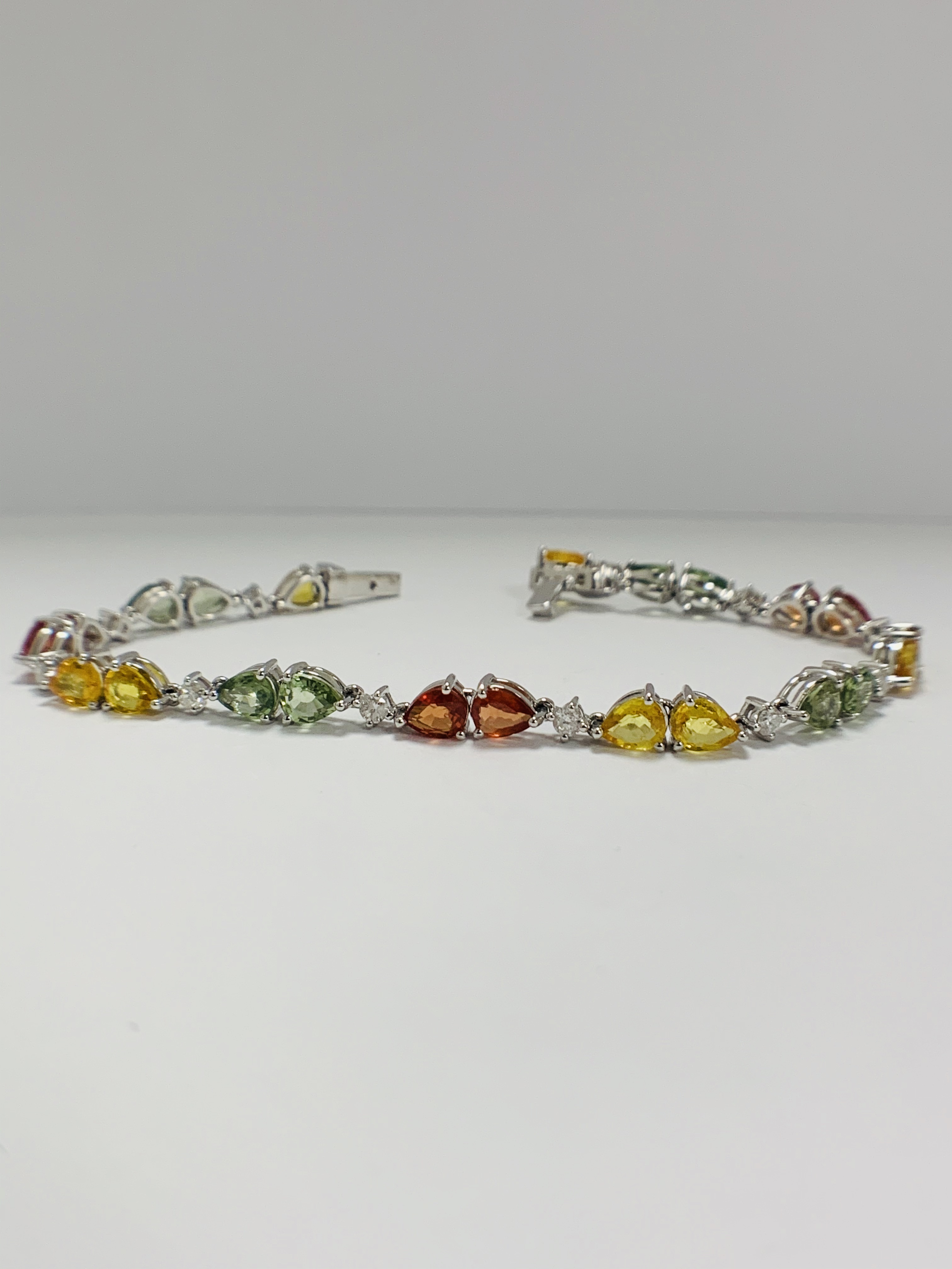 14ct White Gold Sapphire and Diamond bracelet featuring, 22 pear cut, yellow, green and orange Sapph