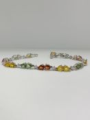 14ct White Gold Sapphire and Diamond bracelet featuring, 22 pear cut, yellow, green and orange Sapph