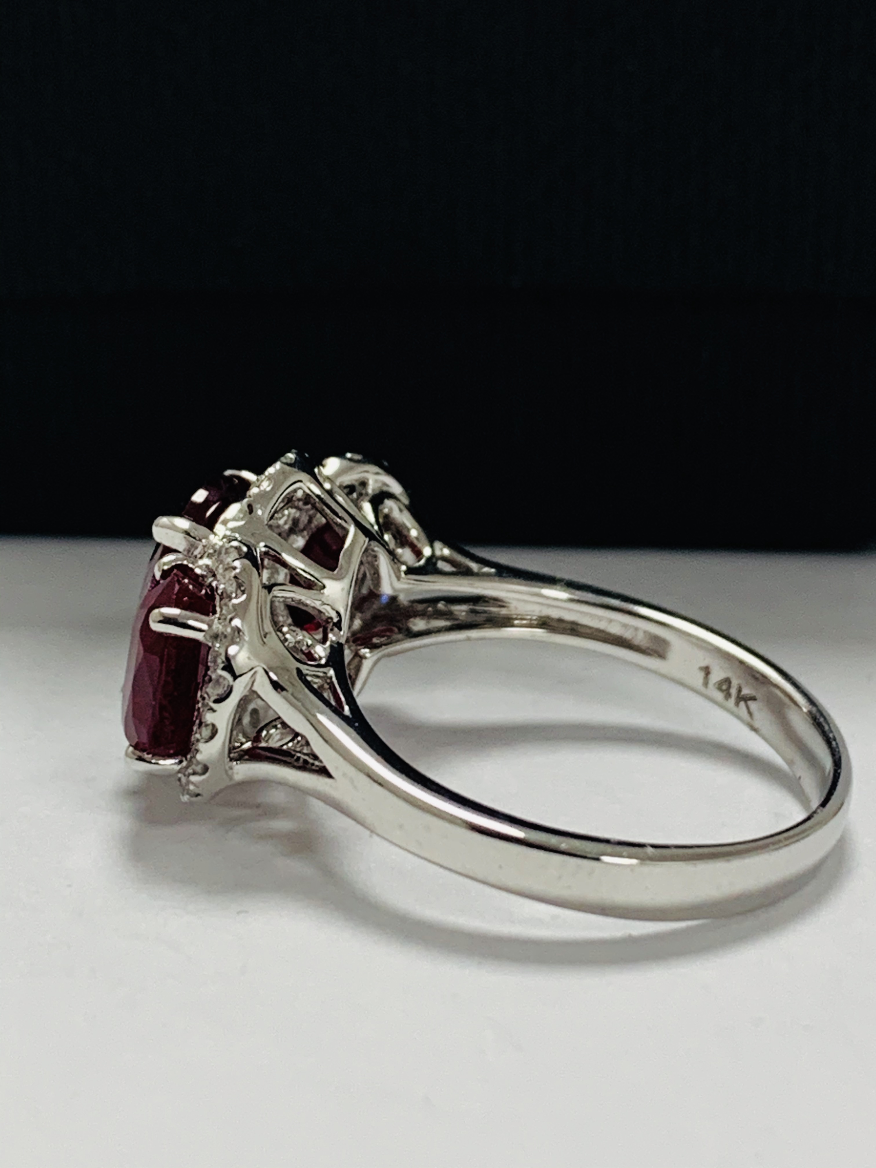 14ct White Gold Ruby and Diamond ring featuring centre, oval cut Ruby (1.67ct), claw set, with 2 ova - Image 4 of 12