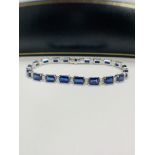 14ct Sapphire and Diamond tennis bracelet featuring, 20 oval cut, blue Sapphires (12.72ct TSW), claw
