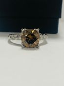 Platinum Diamond ring featuring centre, round brilliant cut, medium yellowish brown Diamond (3.20ct)