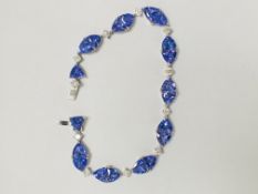 Platinum Tanzanite and Diamond bracelet featuring, 22 trilliant cut, violet blue Tanzanites (14.98ct