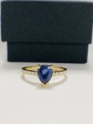 14ct Yellow Gold Sapphire and Diamond ring featuring centre, pear cut, medium blue Sapphire (1.01ct)