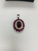 14ct White Gold Ruby and Diamond pendant featuring centre, oval cut, vivid red Ruby, claw set, with