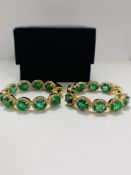 14ct Yellow Gold Emerald and Diamond hoop earrings featuring, 18 oval cut, medium to dark green Emer