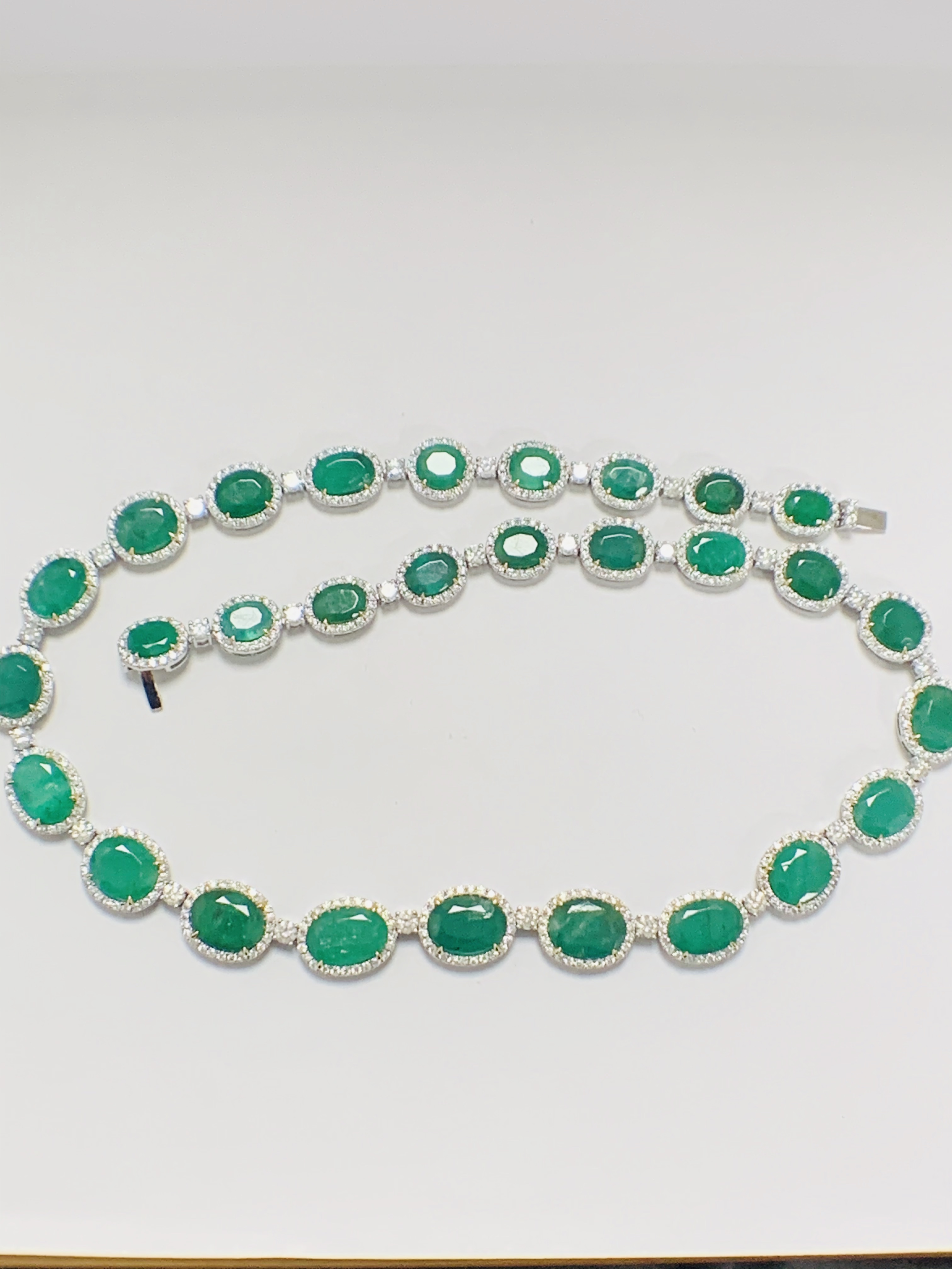 Platinum and Yellow Gold Emerald and Diamond necklace featuring, 29 oval cut, light to deep green Em - Image 8 of 36