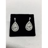 2.04ct diamond drop earrings. Each set with a certificated pear shaped diamond with a halo setting.