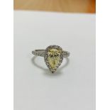 Platinum and 18ct gold fancy yellow diamond halo ring