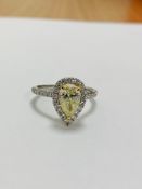 Platinum and 18ct gold fancy yellow diamond halo ring