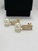 14ct Yellow Gold Pearl and Diamond drop earrings featuring, 2 white South Sea Pearls, with 44 round