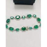 14ct White Gold Emerald and Diamond bracelet featuring, 14 oval cut, medium green Emeralds (11.90ct