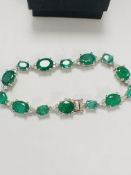 14ct White Gold Emerald and Diamond bracelet featuring, 14 oval cut, medium green Emeralds (11.90ct