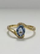 14ct Yellow Gold Sapphire and Diamond ring featuring centre, oval cut, light blue Sapphire (0.77ct),