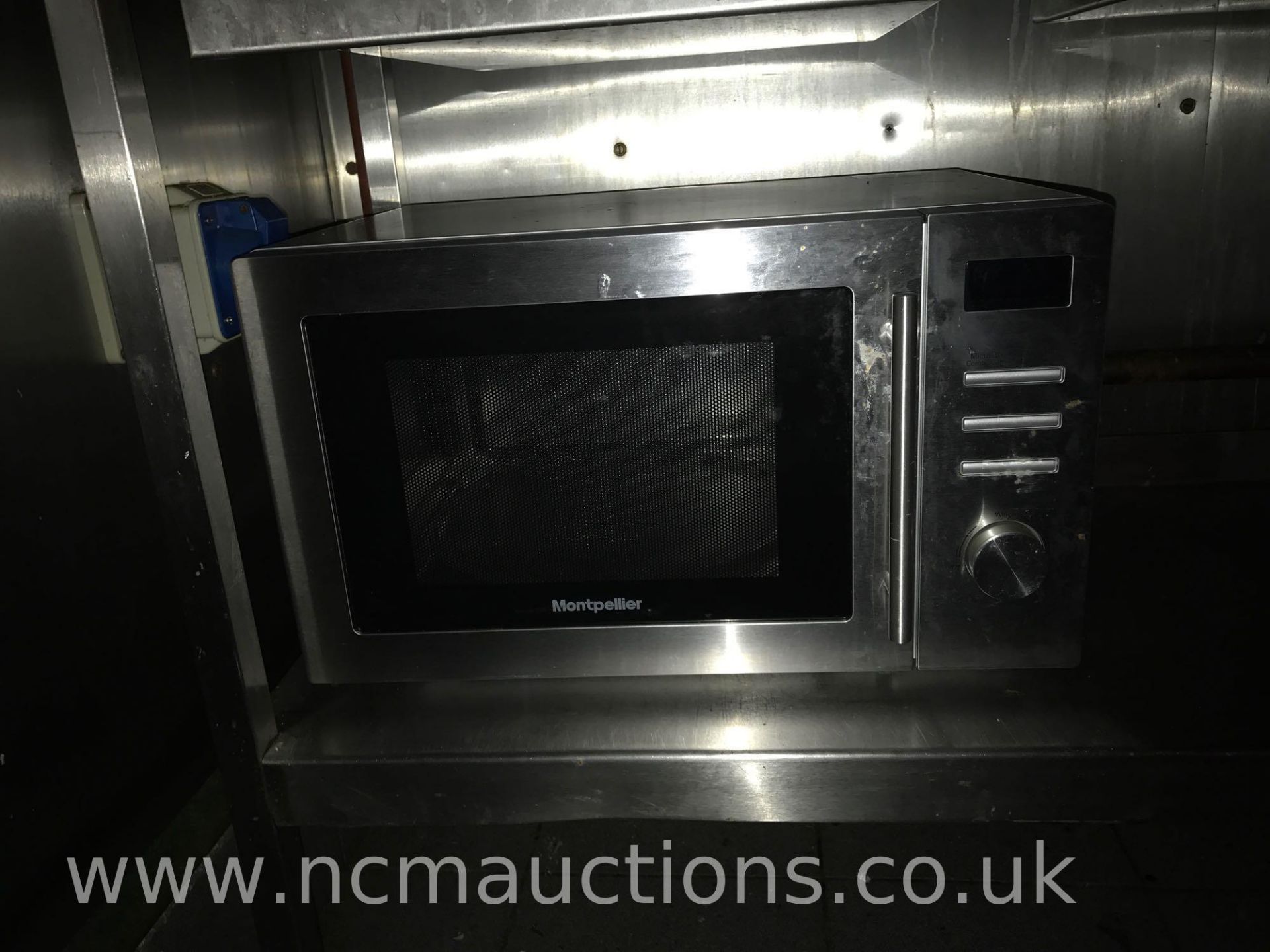 Montpellier microwave and stainless steel counter on caster wheels
