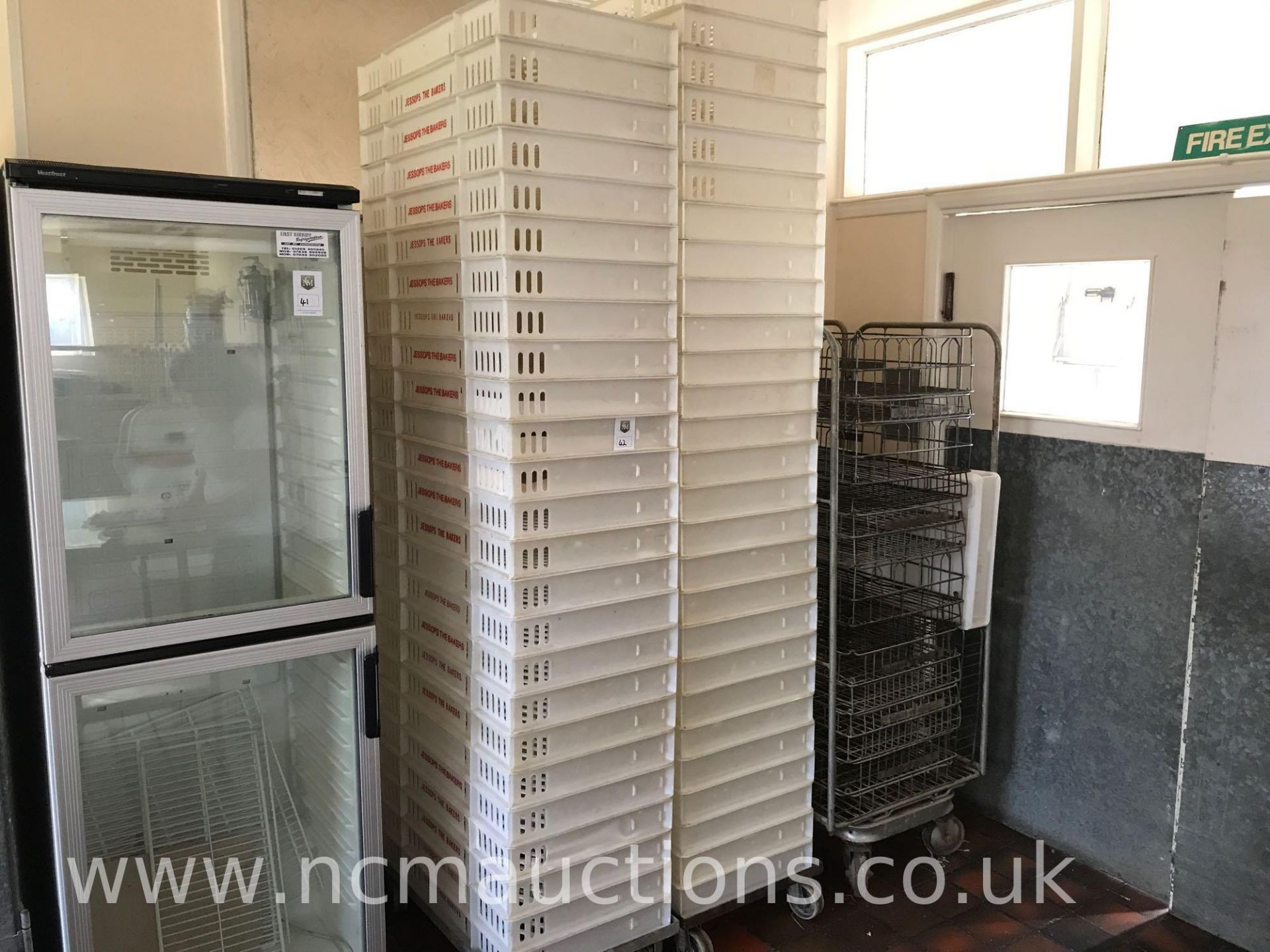 Approximately 50 Plastic Bakery Trays and Trolleys