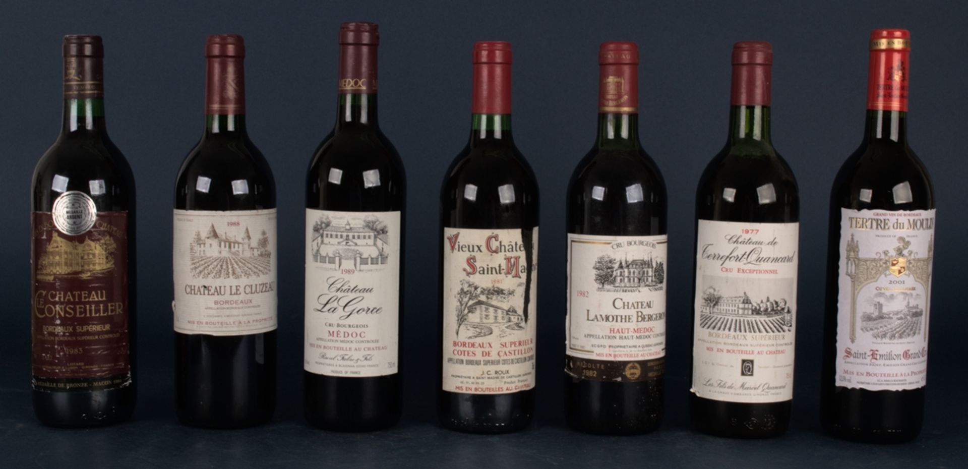 7 verschiedene Flaschen französische Rotweine: 1x 1983er "Chateau Le Couseiller", Bordeaux