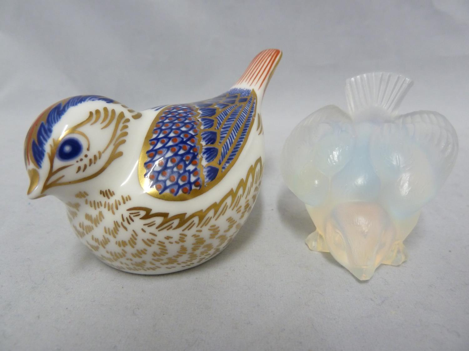 A Sabino glass bird, marked Sabino France; and a Royal Crown Derby Goldcrest bird paperweight, in