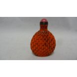 Chinese Glass - a red glass snuff bottle formed to simulate cinnabar lacquer, bronze metal mount
