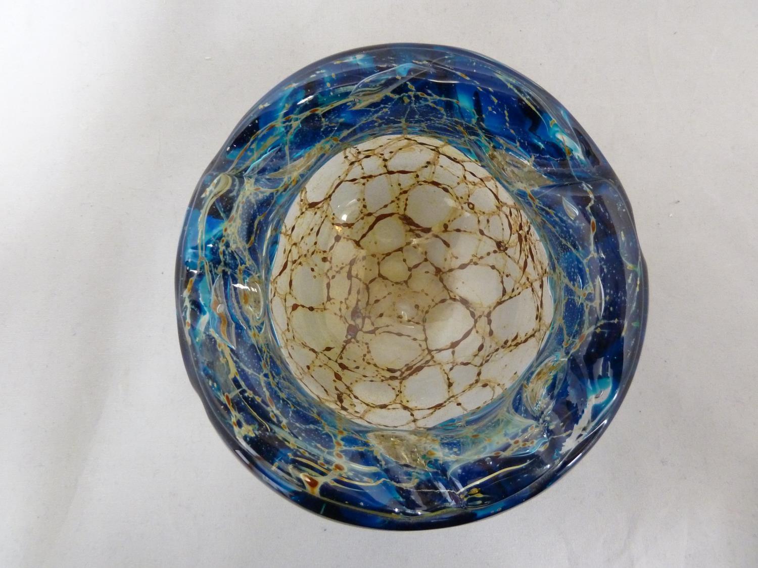 Mdina glass - a bowl with everted rim, the textured blue glass rim folded over a sand and rust