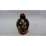 Chinese Glass - a deep amber glass faceted snuff bottle enamelled in polychrome colours with