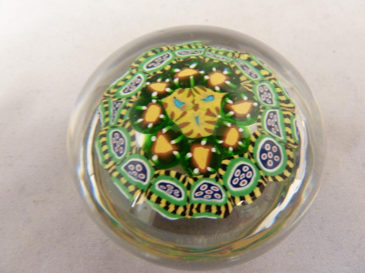 Strathern - a glass paperweight, predominantly of brightly coloured concentric canes in yellow and