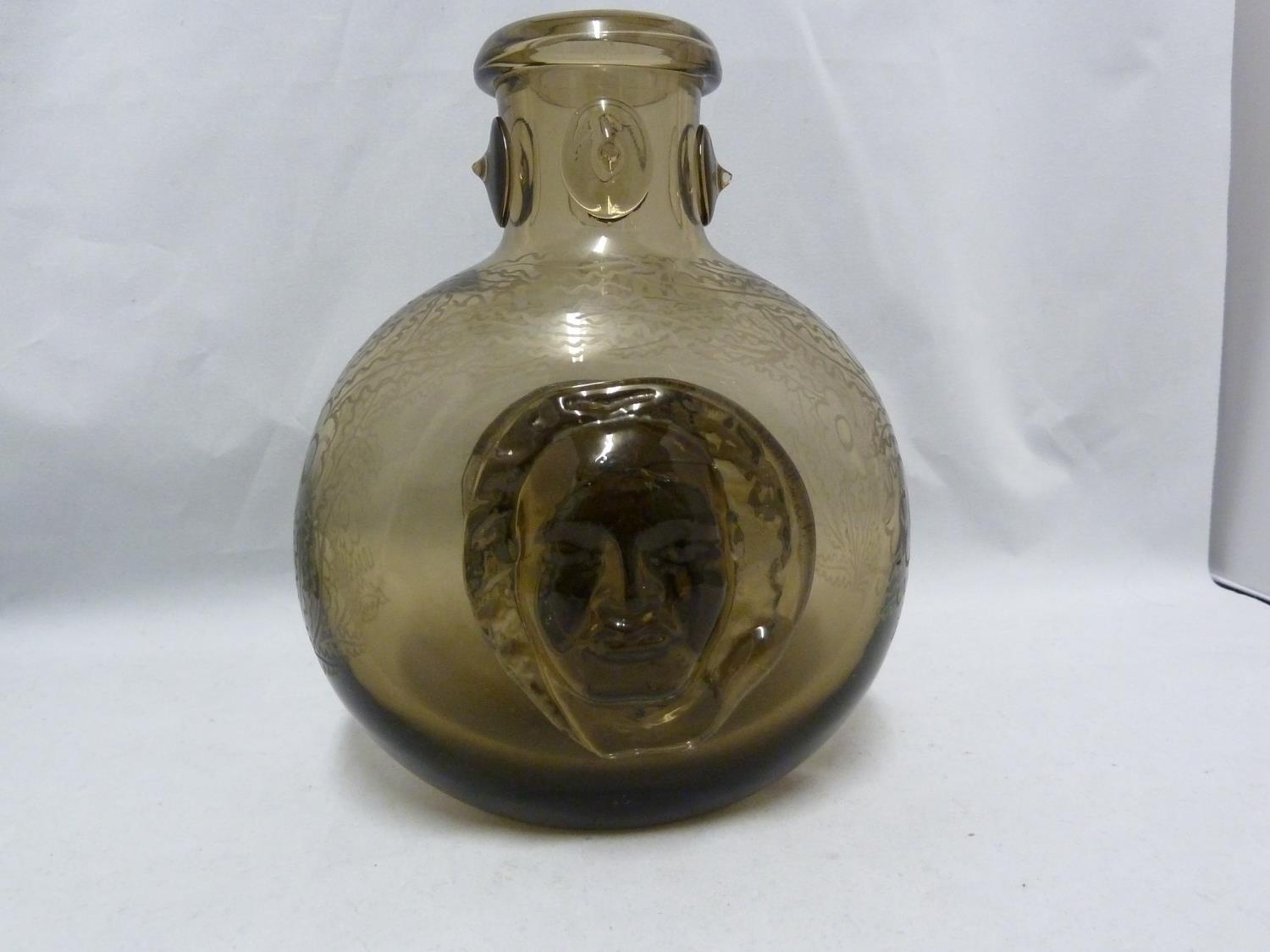 Seguso - a dark amber glass flask, the flattened globular body applied with a female head to each
