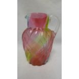 Stevens and Williams - a Rainbow glass jug, of ovoid wrythen moulded body with applied colourless