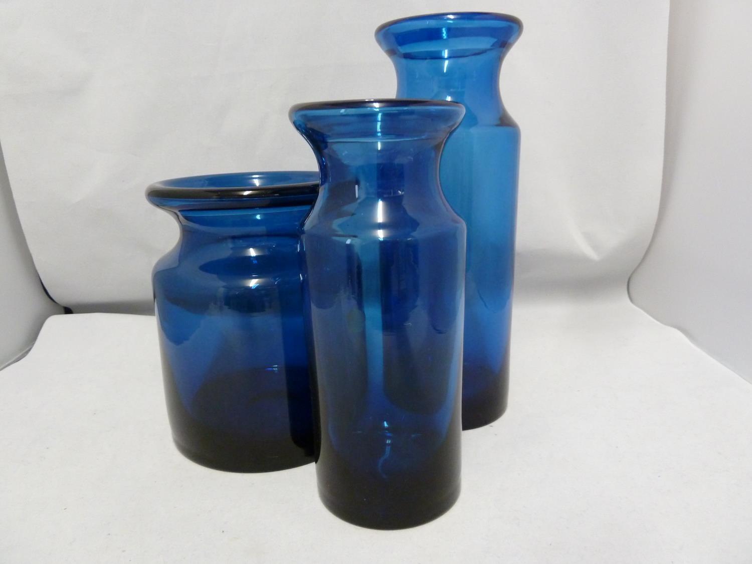 Hovmantorp - three cobalt blue glass vases, of cylindrical form with inverted rims, unmarked, one