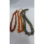 Venetian glass - trade beads, three strings, including a brick red string of cylindrical beads and